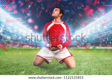 Football player exults in a full stadium