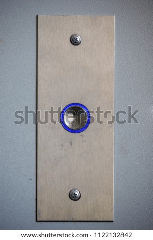 blue elevator button close-up
