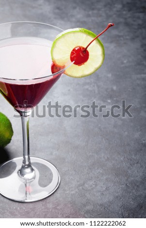 Cosmopolitan cocktail on dark stone table. With space for your text