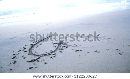 Beautiful heart on sand beach background.