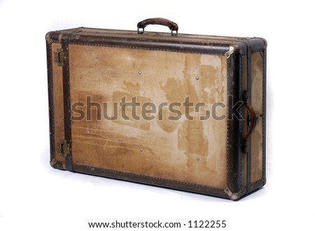 A battered old suitcase shows the traces of luggage labels from world travel Royalty-Free Stock Photo #1122255