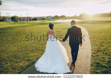 beautiful wedding couple on the Golf course during sunset