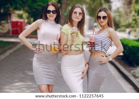 three young models are walking around the city on a warm summer day