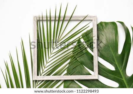 Beautiful composition with tropical leaves on light background, top view