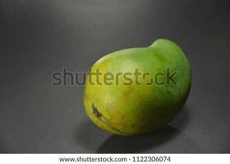 Fresh delicious mango fruit on black background