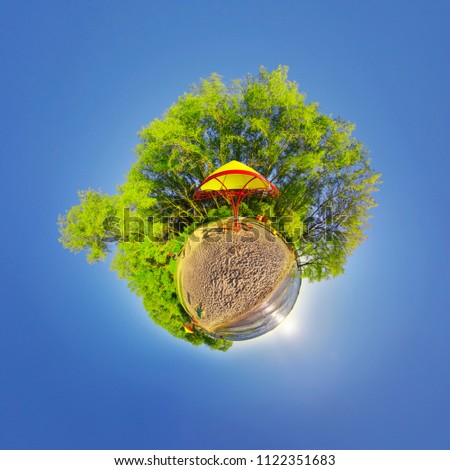 Green little planet with trees and soft blue sky. Tiny planet sunset at the beach. 360 viewing angle. World. Planet Earth.