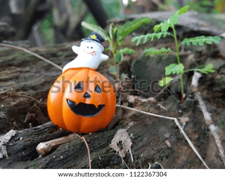 Halloween pumpkin with ghosts in the forest. Select focus