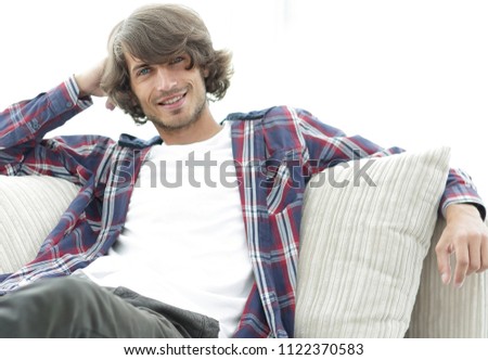 serious modern guy sitting on the couch