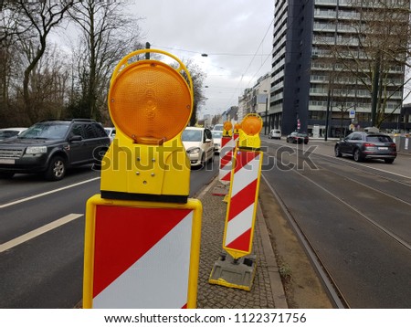 Orange road marking pole with reflectors.