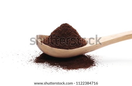 Pile of powdered, instant coffee with wooden spoon isolated on white background