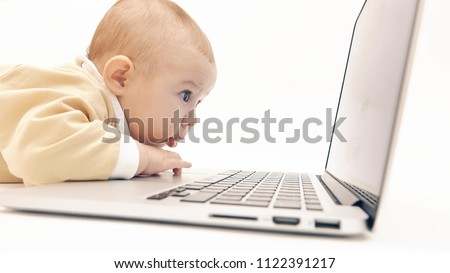 Cute baby working on a laptop Royalty-Free Stock Photo #1122391217