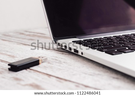 Woman hand entering inserting usb flash into laptop computer