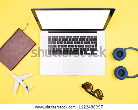 Traveler businessman top view yellow desk concept image,sunglasses, headpphones, pot of grass 