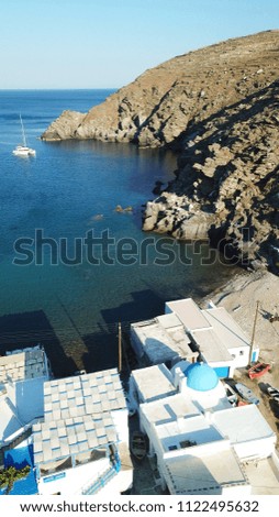 Aerial drone bird's eye view picturesque small settlement by the sea of Seralia just below iconic village of Kastro, Sifnos island, Cyclades, Greece