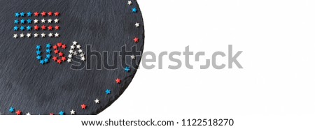 American flag and word USA concept 4th July Independence Day. Round slate background. Web banner. Top view. Copy space. Selective focus.