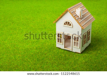 White small house on green grass
