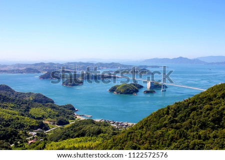 The Seto Inland Sea, also known as Setouchi or often shortened to Inland Sea, is the body of water separating Honshū, Shikoku, and Kyūshū, three of the four main islands of Japan. Royalty-Free Stock Photo #1122572576