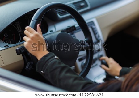 Girls hands on the steering wheel