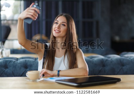 A young girl is taking selfie