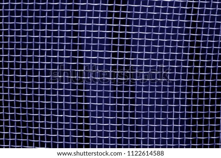 Metal mesh grid pattern in blue tone. Abstract background and texture.