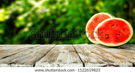 Fresh watermelon on desk and green background 