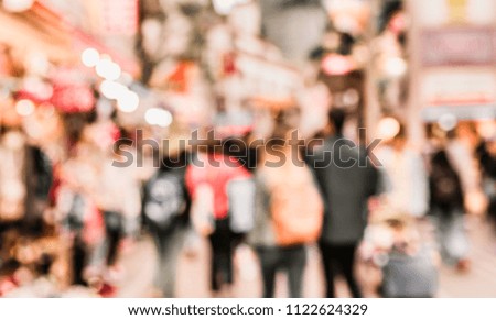 Abstract Blurred image of People walking at footpath on day time with bokeh for background usage .(vintage tone)