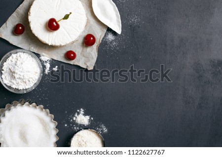Dairy Products, Flour, Sugar and Cherries on Black Background, copy space