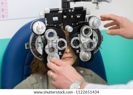 Ophthalmologist who uses an equipment to measure sight to a child