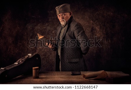 Portrait of Ancient Novelist holding book with vintage textured background Royalty-Free Stock Photo #1122668147