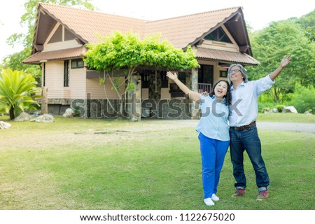 asian senior couple relax on nature background, husband and wife feeling happy, traditional home on nature background