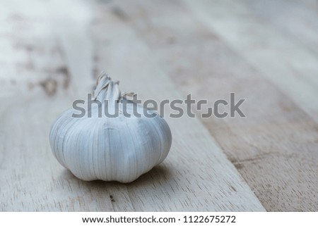 Fresh raw garlic on wooden table, kitchen raw ingredient concept, copy space