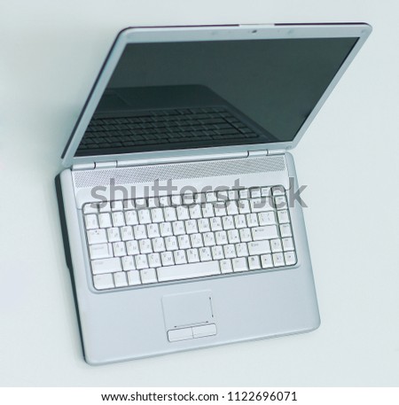 open laptop computer and blank business card on the Desk of a businessman