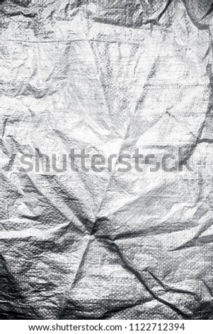 Close up of white colored crumbled plastic texture or background used as  a wallpaper or a theme in websites.