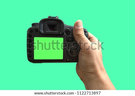 Camera in hand on isolated green screen, path included