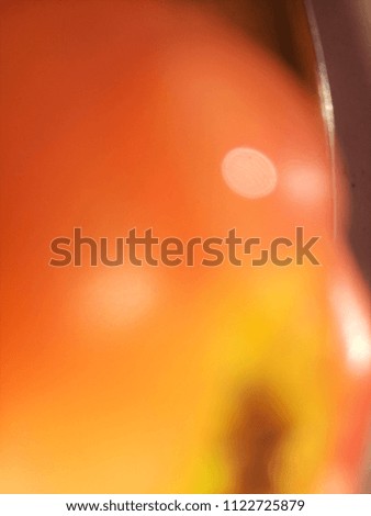 Abstract out of focus lights coming from the mother nature with abstract background of Red Apple fruit. Abstract background of Red, Yellow and white color. 