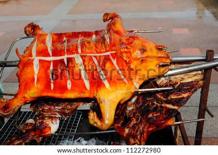 whole body grilling pork on hot stove