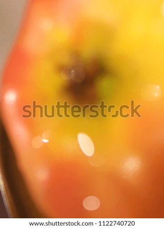 Abstract out of focus lights coming from the mother nature with abstract background of Red Apple fruit. Abstract background of Red, Yellow and white color. 