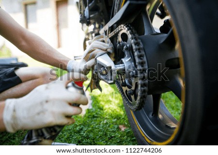 Man hands cleaning motorbike doing maintenance by rag and by detergent