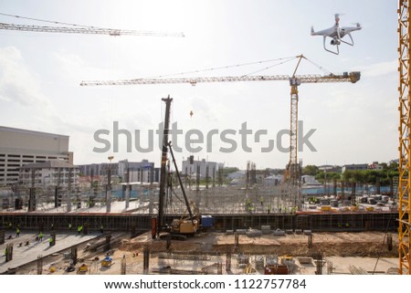 Drone over construction site. video surveillance or industrial inspection. drone copter flying with digital camera.Drone with high resolution digital camera. Flying camera take a photo and video.
