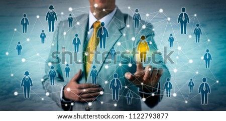 Unrecognizable marketing executive selecting one female customer in a professional network. Business technology concept for CRM, talent sourcing, networking, prospecting, targeting, recruitment. Royalty-Free Stock Photo #1122793877