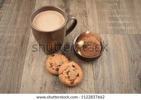 Cookies with milk on a wooden background stock images. Cookies with chocolate milk stock images. Biscuits on a wooden background. Cup of chocolate milk with snack