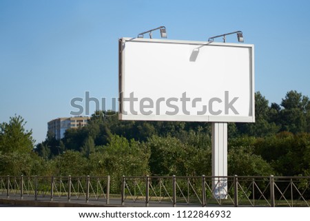 Blank white billboard against the blue sky. billboard. mocap to showcase your advertising design banners. white advertising field 3 by 4 meter layout with a shadow from the sun. realistic image