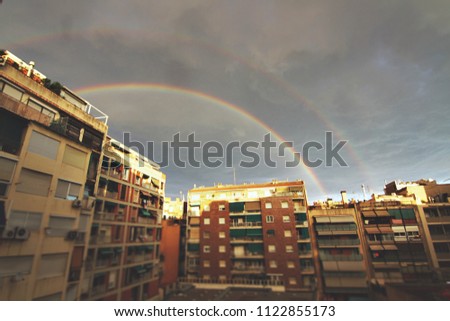 A rainbow in the sky after a storm in city