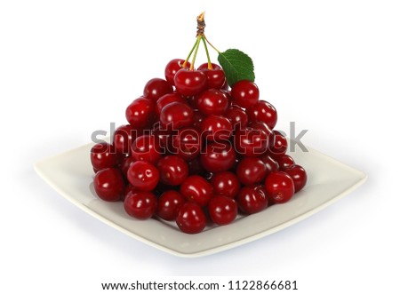Composition of cherries on a white plate isolated on white background. A bunch of cherries with clipping path.