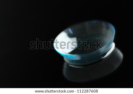 Close-up of contact lens on black background.