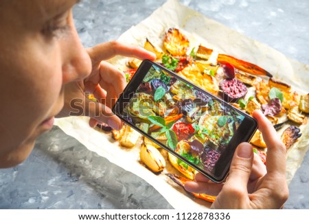 Taking photo of vegetables on a hot baking sheet