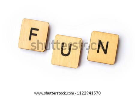 The word FUN spelt out with wooden lettered tiles.