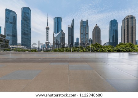 Panoramic skyline and modern business office buildings with empty concrete square floor