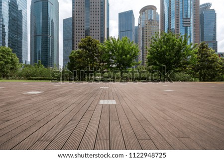 Panoramic skyline and modern business office buildings with empty concrete square floor