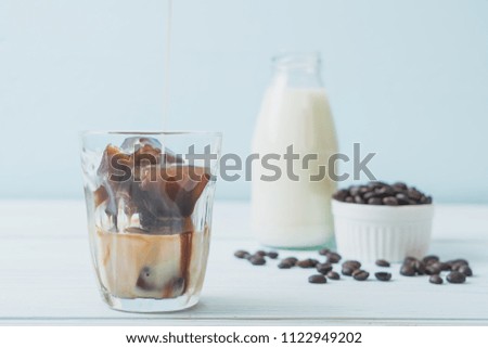 coffee ice cubes with milk on wood table